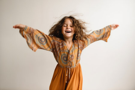 child girl that is wearing a flowy bohemian jumpsuit against a white backgroundの素材