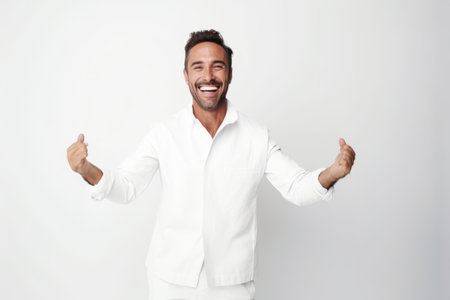 Portrait of a happy young man celebrating success isolated over white backgroundの素材