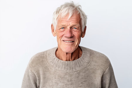 Portrait of a happy senior man looking at camera isolated on white backgroundの素材