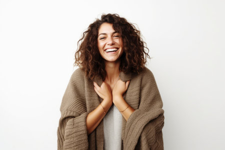 Portrait of beautiful young woman with curly hair laughing and looking at camera.の素材