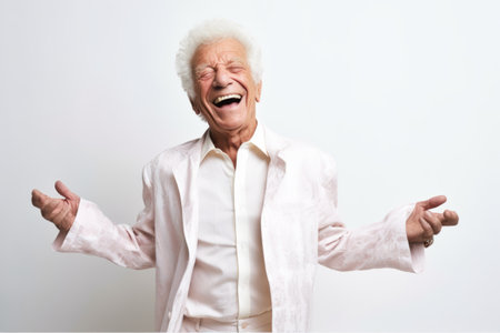 Portrait of happy senior Asian man laughing on white background.の素材