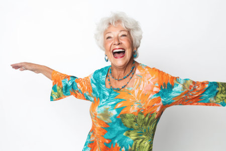 Portrait of a happy senior woman dancing isolated on a white backgroundの素材