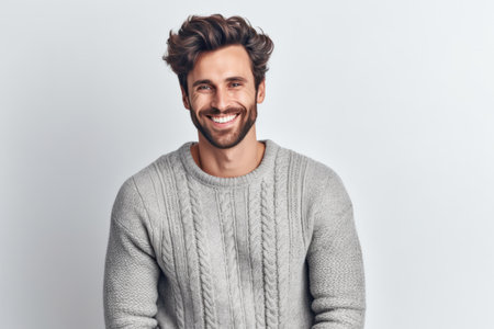 Portrait of handsome young man in sweater smiling and looking at cameraの素材