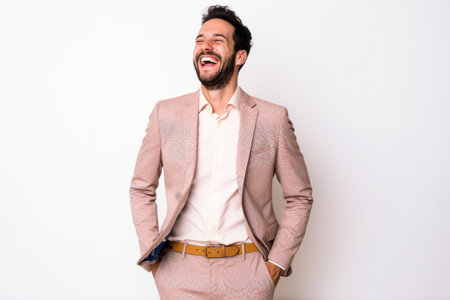 Handsome man laughing and looking at the camera on white backgroundの素材
