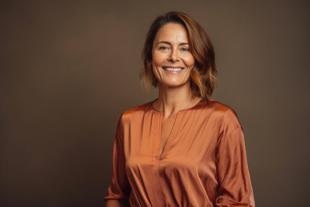 Portrait of a beautiful middle aged woman smiling at the camera.の素材