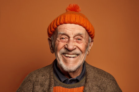 Portrait of a happy senior man in a warm hat and sweater.の素材