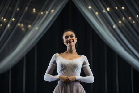 Portrait of beautiful young ballerina in white dress on stageの素材