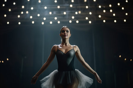 Beautiful ballerina in a black tutu dancing on stageの素材