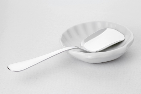 Porcelain plate and spoon for caviar on a white tableclothの写真素材