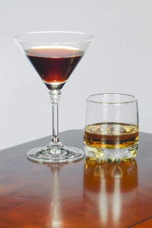 On the table red wine in a glass for wine and whiskey in a glassの写真素材