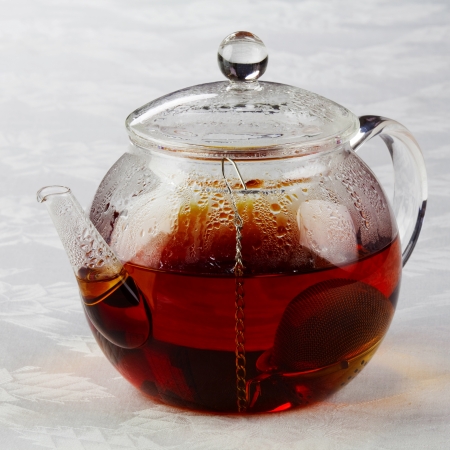 Teapot with tea and tea strainerの写真素材