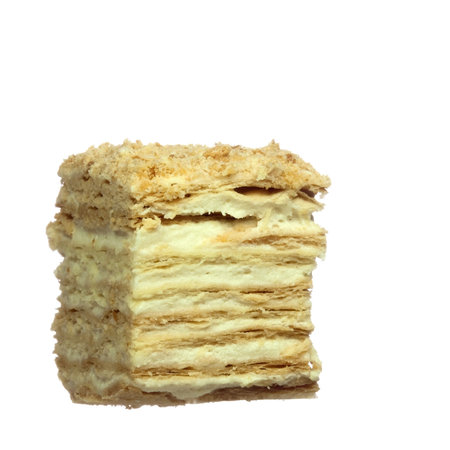 Slice of layer cake with custard, isolated on whiteの写真素材
