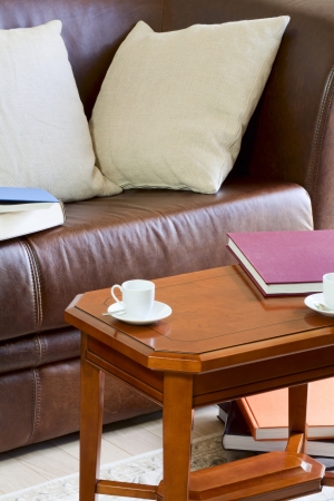 Couch and coffee table, on the table is book and coffee cupsの写真素材