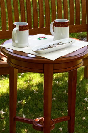 Beer mugs and dried fish on the table in the gardenの写真素材