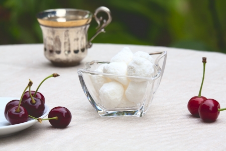 Beautiful summer breakfast - cherries, sweets, teaの写真素材