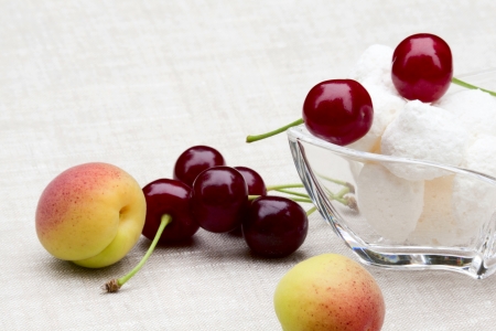 Beautiful summer breakfast - cherries, apricots, sweetsの写真素材
