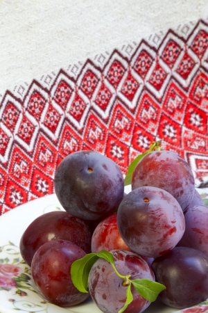 Ripe plums on a bright colored backgroundの写真素材