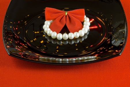 Bracelet of pearls among the reflections of colored lightsの写真素材