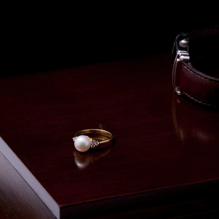 Gold ring with pearl and diamond black backgroundの写真素材