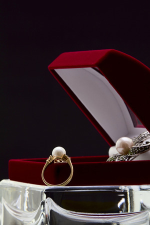 Ring and brooch with pearls in a box for jewelryの写真素材