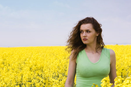 Portrait of a sad woman in rape flower field