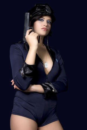 Sexy woman with police uniform in studio  on dark gradient backgroundの写真素材