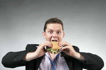 Young man ready to eat his burger. Studio shotの写真素材