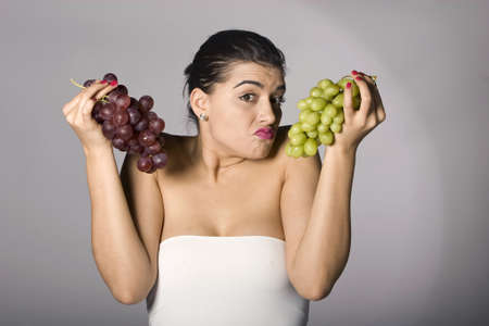Part of photo series. Woman with mix of grapes. Studio shotの写真素材
