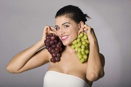 Part of photo series. Woman with mix of grapes. Studio shotの写真素材