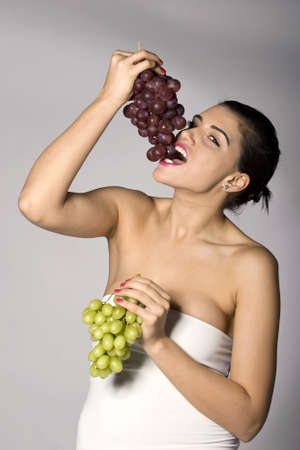 Part of photo series. Woman with mix of grapes. Studio shotの写真素材