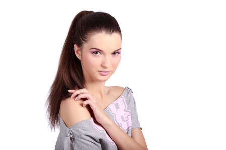 Portrait of a pretty young woman with ponytail hair and pink natural makeup. High resolution image taken in studio. Isolated on pure white background with copy space for your ad.の写真素材