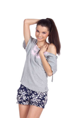 Shy beautiful young model standing and posing looking at the camera. High resolution image taken in studio. Isolated on pure white background with copy space for your ad.の写真素材