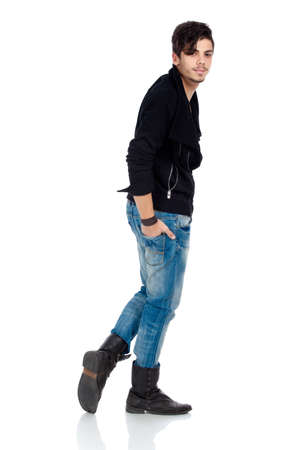 Handsome young fashion model wearing jeans, boots and a black jacket. Isolated on white background. Studio vertical image.の写真素材