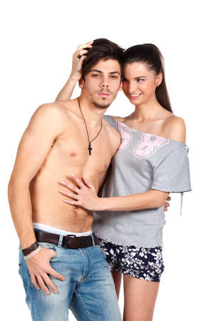 Happy young couple flirting and playing, topless man, casual clothes. Isolated on white background. High resolution studio image.の写真素材