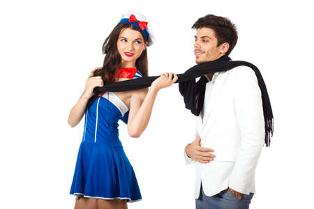 Attractive young sailor woman seducing elegant man. Isolated on white background. High resolution studio imageの写真素材