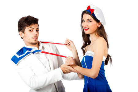 Sexy sailor woman seducing young elegant man. Isolated on white background. High resolution studio imageの写真素材