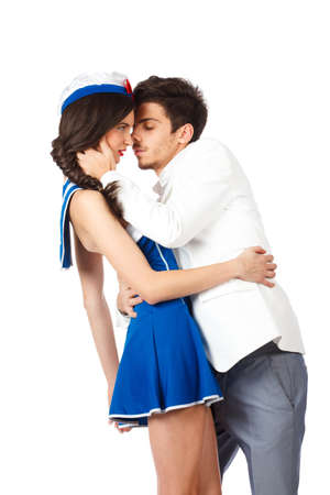 Young couple. Elegant man kissing sailor woman. Isolated on white background. High resolution studio imageの写真素材