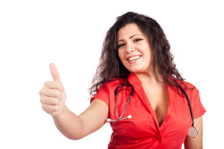 Beautiful happy young nurse or medical woman doctor with big breasts, wearing tangerine tango orange uniform dress , smiling, with thumb up. Isolated  on white background with text space. High resolution studio image.の写真素材