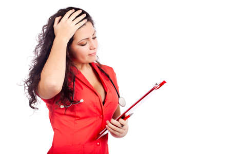 Bad news for a  professional young nurse or medical woman  doctor with big breasts, wearing tangerine tango orange uniform dress ,with clipboard. Isolated on white background with text space. High resolution studio image.の写真素材