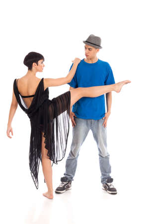 A couple of two young, attractive, modern ballet dancers, one woman and one man,  in dynamic action figure, with hands and legs raised up in the air, on white background, studio image.の写真素材