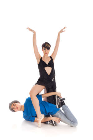 A couple of two young, attractive, modern ballet dancers, one woman and one man,  in dynamic action figure, on white background, studio image.の写真素材