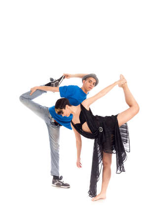 A couple of two young, attractive, modern ballet dancers, one woman and one man,  in dynamic action figure, with hands and legs raised up in the air, on white background, studio image.の写真素材