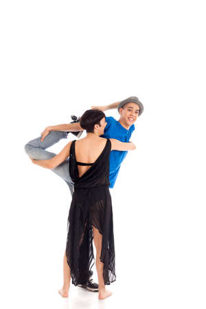 A couple of two young, attractive, modern ballet dancers, one woman and one man,  in dynamic action figure, warming up, on white background, studio image.の写真素材