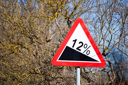Road sign steep climb on wood backgroundの写真素材