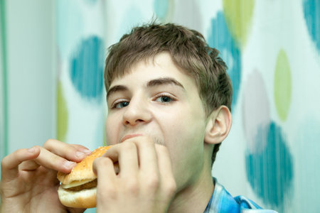 Teenager with burgerの写真素材