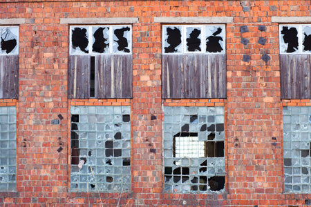 facade of the ruined building with broken windows created from the red bricks