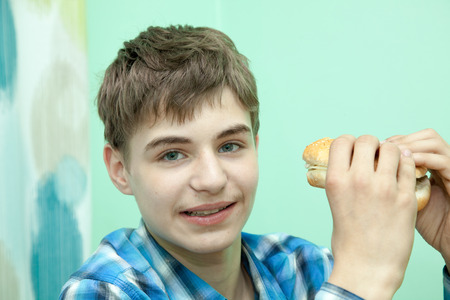 Teenager with burgerの写真素材
