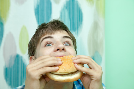 Teenager with burgerの写真素材