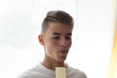 Beautifully cut boy eating chipsの写真素材