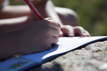 Boy's hand drawing a pencilの写真素材